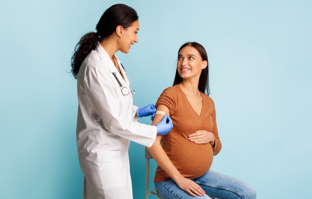 pregnant woman receiving vaccines in Howard County