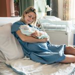 woman with baby after her VBAC in Howard County