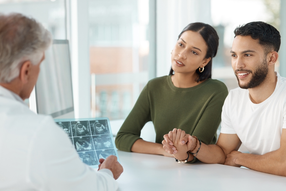 couple talking to doctor about each trimester ultrasound and what to expect